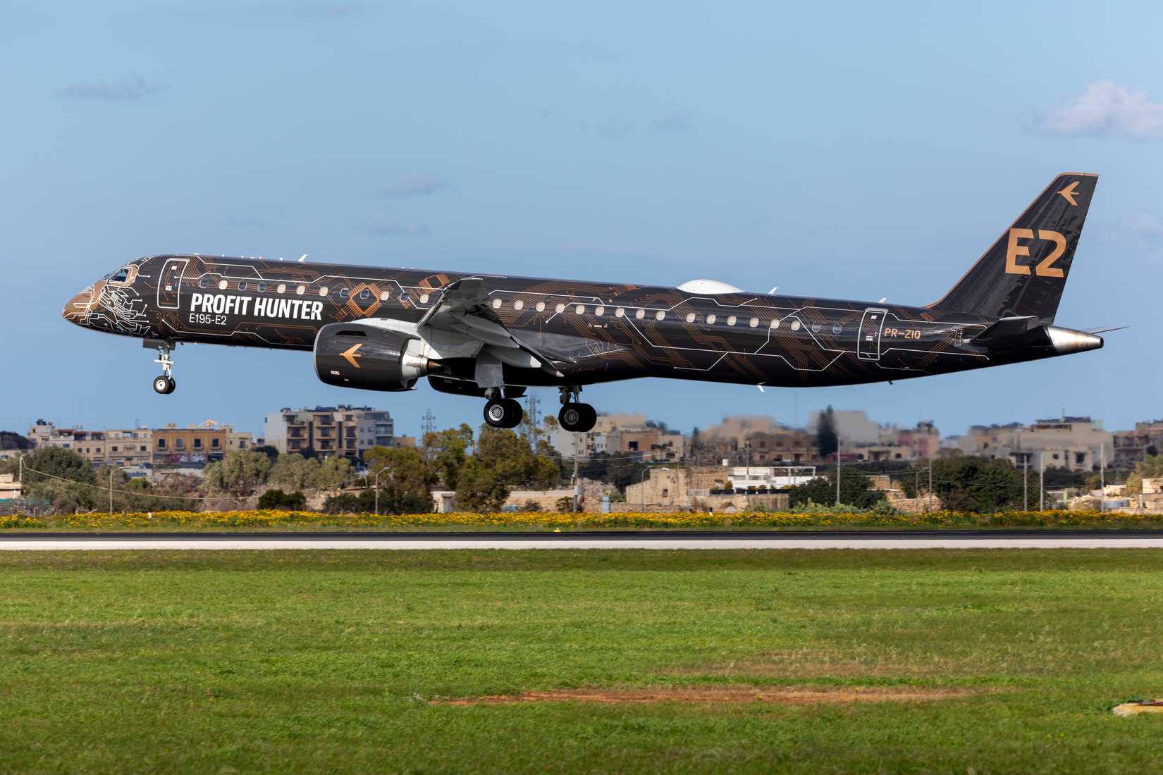 E195 E2 aircraft with profit hunter livery coming in to land