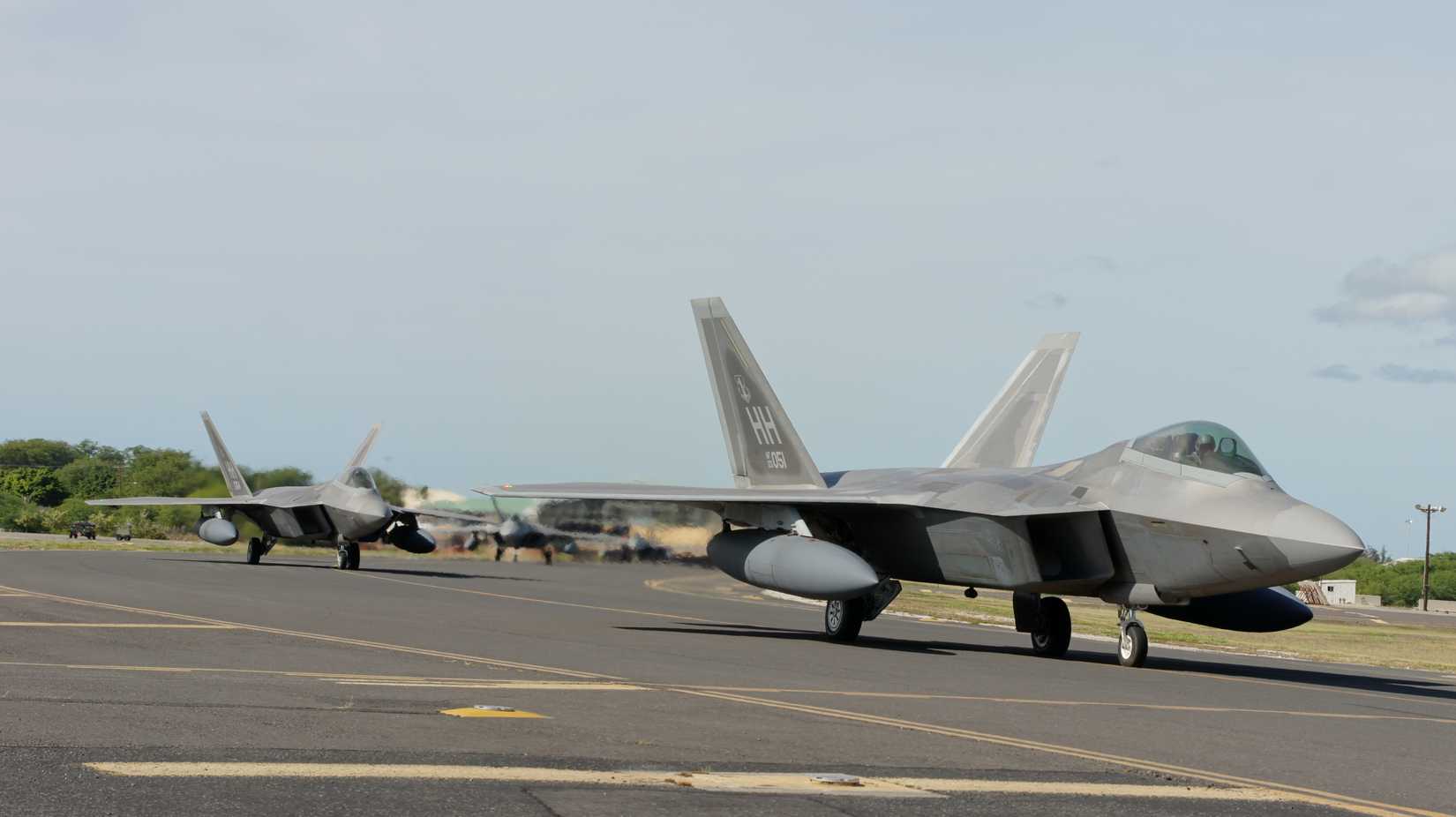 Hawaii based F-22s from the Hawaii Air National Guard's 199th Fighter Squadron and the active duty Air Force's 19th Fighter Squadron loaded with external fuel tanks