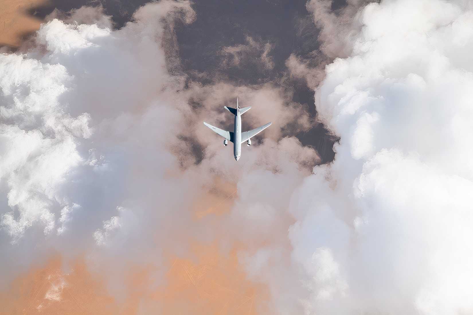 A KC-135 flying among different colored clouds.