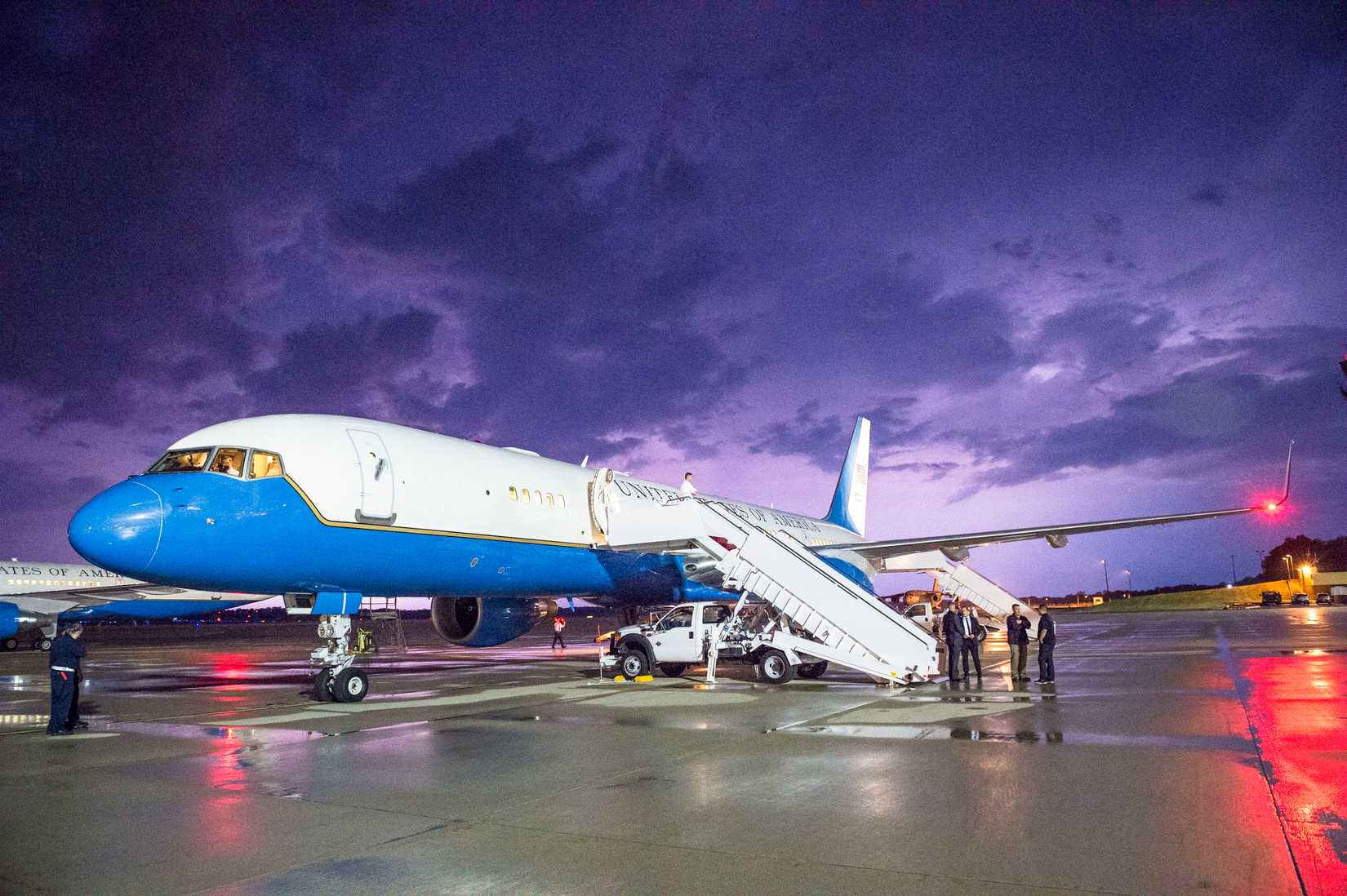Lightning illuminates the sky behind a military C-32A (Boeing 757) parked on Joint Base Andrews, Md., May 18, 2015.