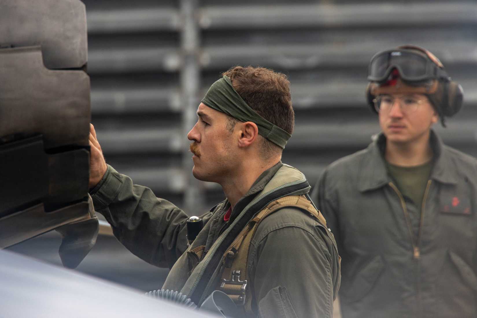 Marine Corps Capt. Trevor Fox, a pilot with Marine Fighter Attack Squadron 232, Marine Aircraft Group 12, 1st Marine Aircraft Wing, preflight checks an FA-18 Hornet.