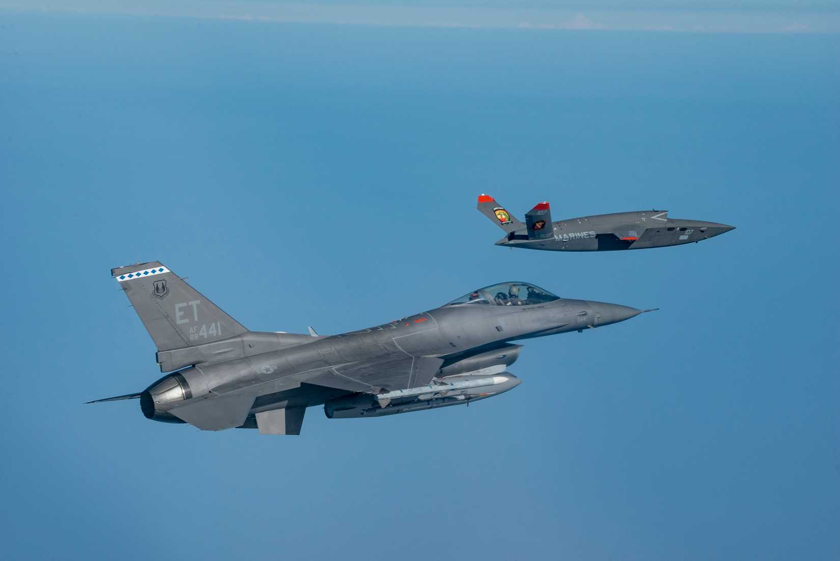 Marine Corps XQ-58A Valkyrie, highly autonomous, low-cost tactical unmanned air vehicle, conducts its first test flight with a U.S. Air Force F-16 Fighting Falco