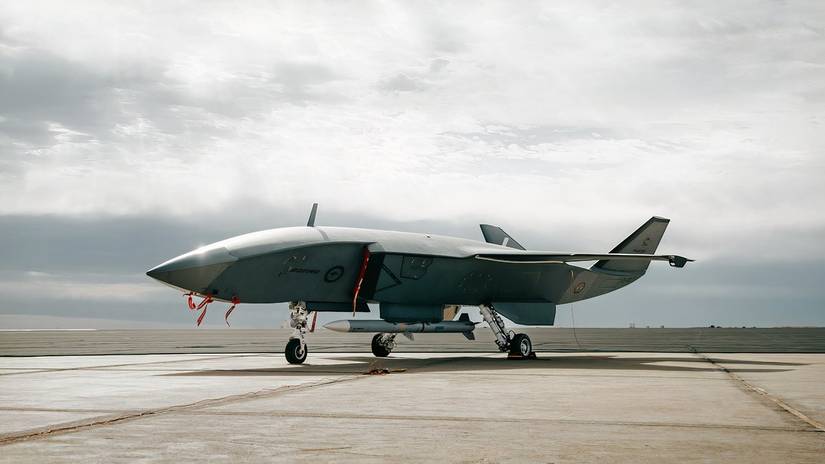 A photo of an MQ-28 Ghost Bat parked, armed with a missile.