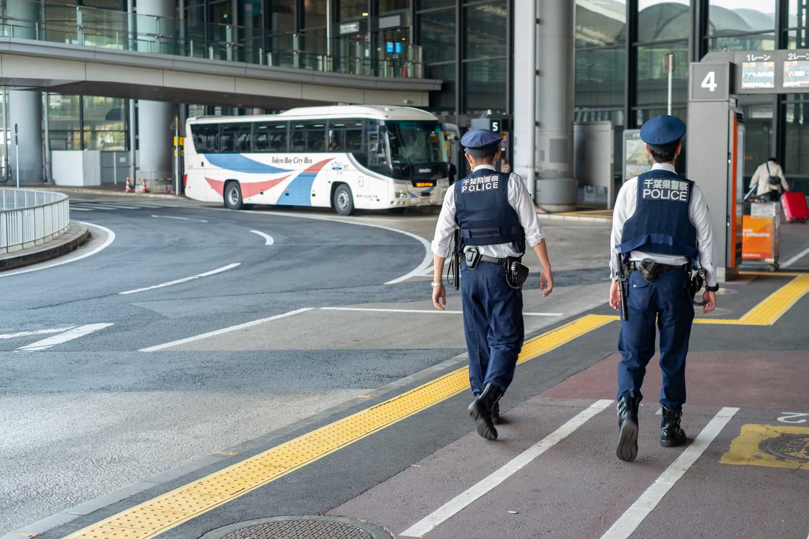 Narita airport police officers patrol around the terminal and keep order