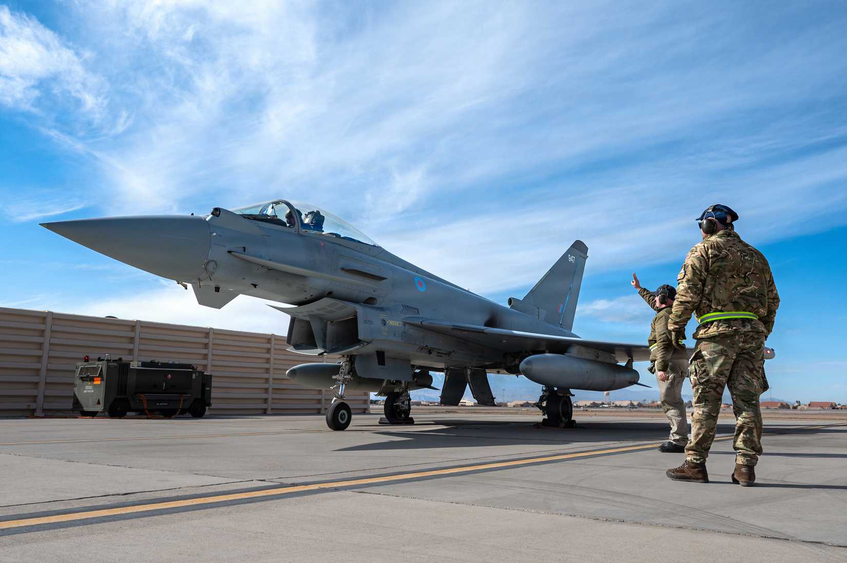 Royal Air Force Senior Aircraftman Technician Daniel Pinches uses hand signals to communicate with a Eurofighter Typhoon FGR4 pilot at Nellis Air Force Base, Nevada, Jan. 26, 2026.