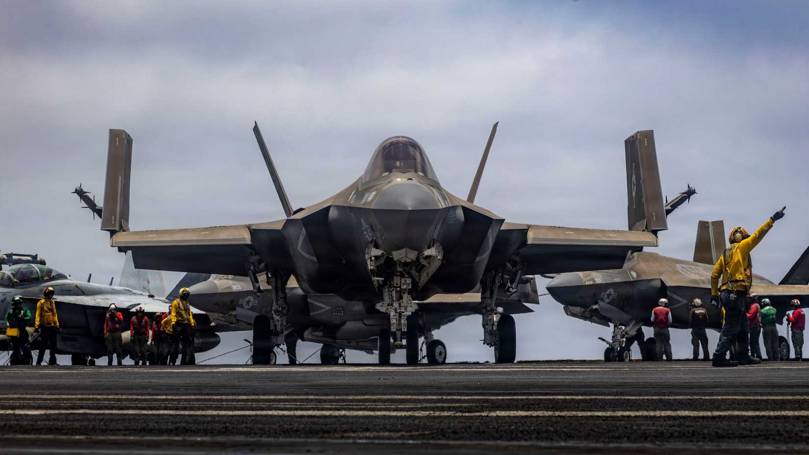 Sailor directs an F-35C Lightning II, attached to Marine Fighter Attack Squadron (VMFA) 314, on the flight deck of Nimitz-class aircraft carrier USS Abraham Lincoln (CVN 72).