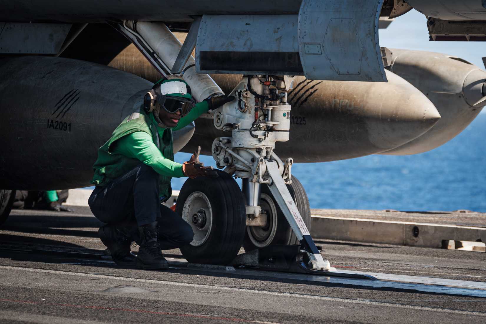 Sailor signals for an aircraft catapult shuttle on USS Gerald R. Ford (CVN 78)