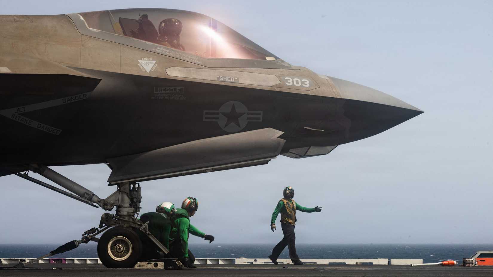 Sailors prepare an F-35C Lightning II, attached to Marine Fighter Attack Squadron (VMFA) 314, to launch from the flight deck.