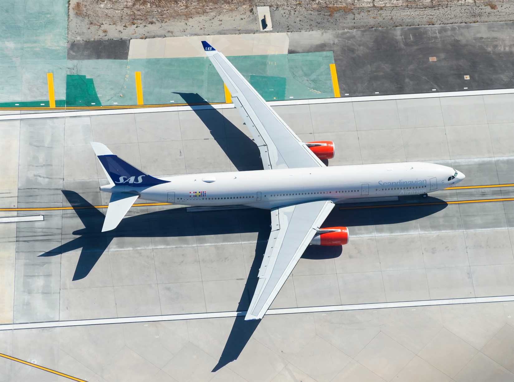 Scandinavian Airlines Airbus A330 rolling in the runway for departure from international airport.