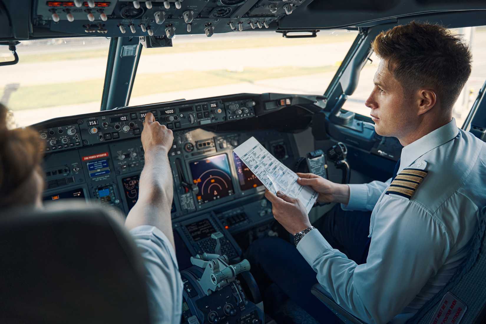 Airline captain and first officer sitting in the cockpit