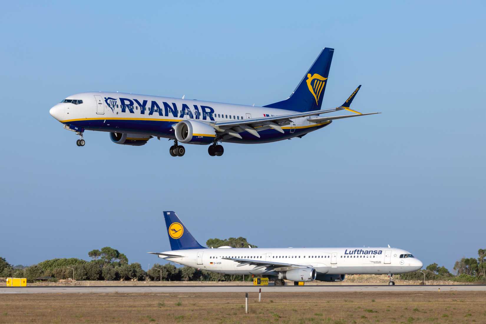 Luqa, Malta - August 2, 2023: Ryanair (Malta Air) Boeing 737-8 MAX 200 (REG: 9H-VVG) coming in for landing as Lufthansa A321 (D-AISR) awaits take off clearance.