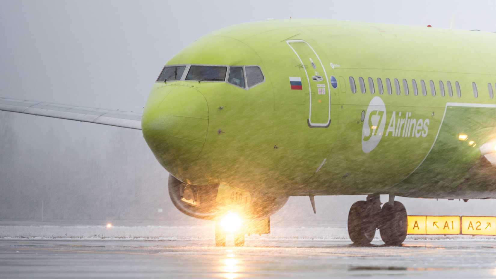 Pulkovo International Airport, Saint-Petersburg, Russia - 09.10.2023: S7 Airlines Boeing 737-800 taxiing to the stand in a heavy snow.