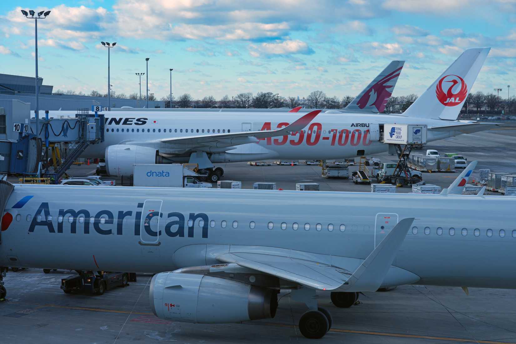 JAL Airbus A350-1000 Parked In Front Of An American Airlines A321-200