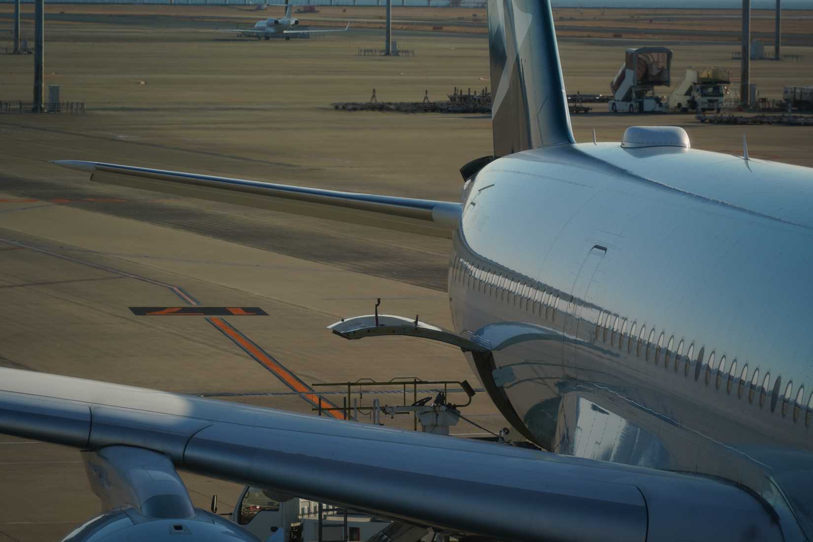 Close-up of the SATCOM antenna dome on the top of a plane at the airport.