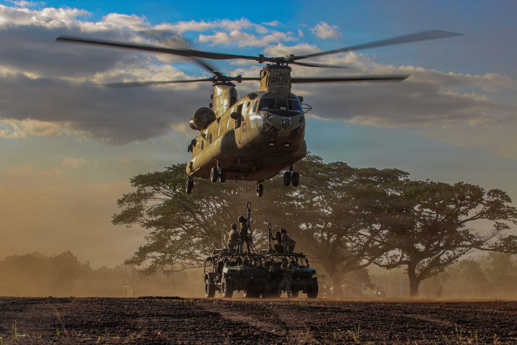  Soldiers sling load Infantry Squad Vehicles to a Boeing CH-47 Chinoo