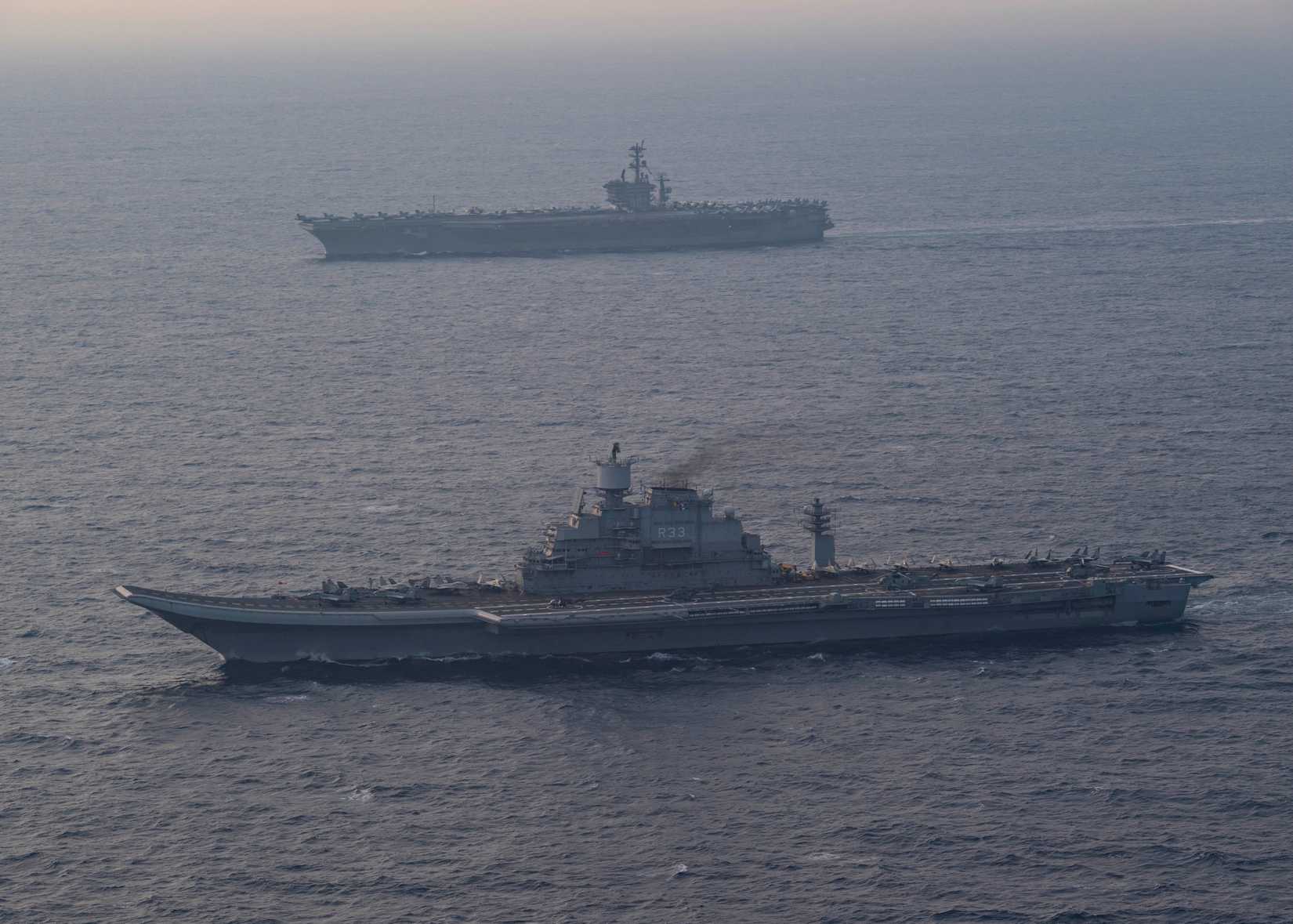 The Kiev-class aircraft carrier INS Vikramaditya (R 33) and the aircraft carrier USS Nimitz (CVN 68) steam in formation.
