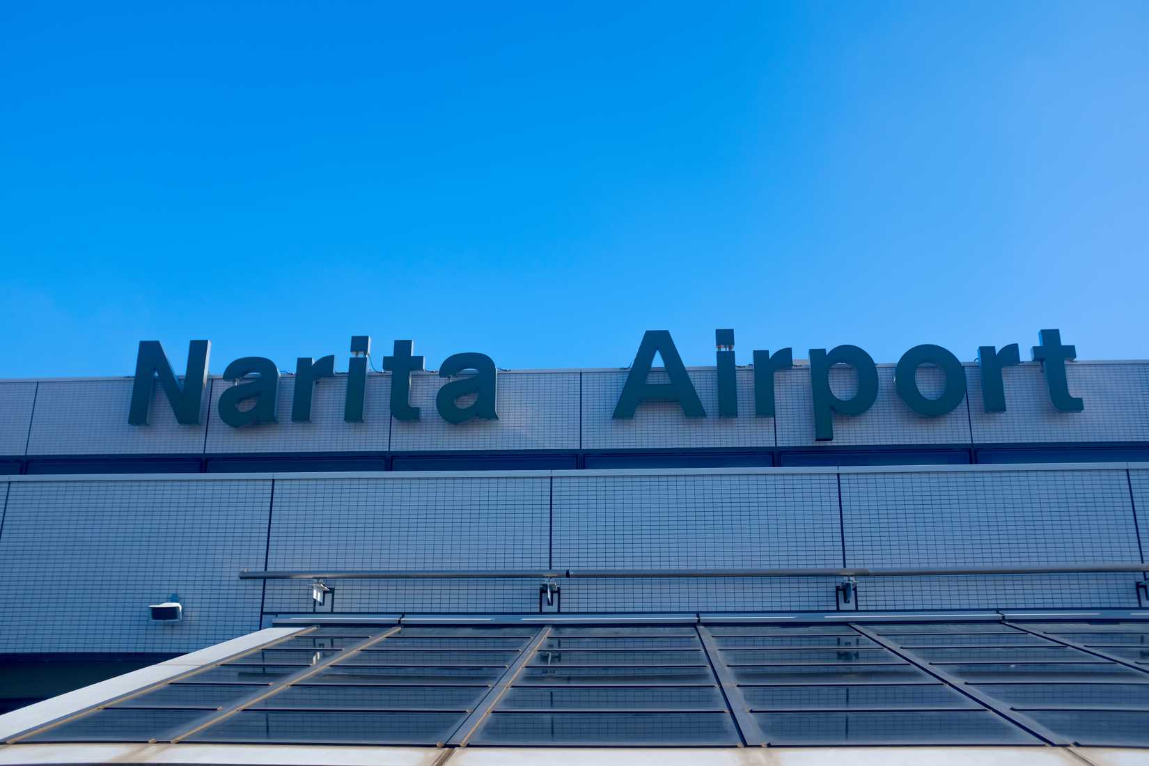 View of the Narita Airport Terminal 1 signage on top of the terminal building at Narita Airport 