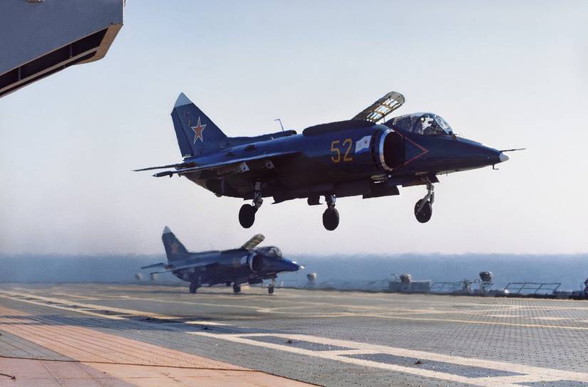 Photo of a Yak-38 making a landing on an Soviet aircraft carrier at sea.
