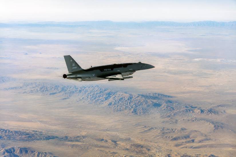 A photo of a YFQ-44A  Fury drone flying over the Mojave Desert at Edwards AFB.