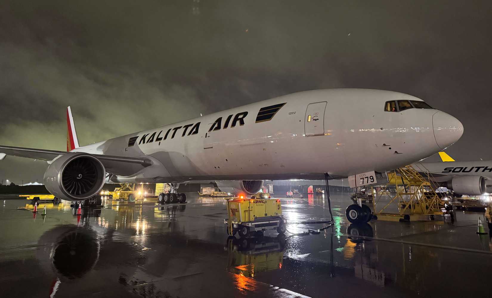 Kalitta Air Boeing 777-300ERSF parked on stand with GPU attached