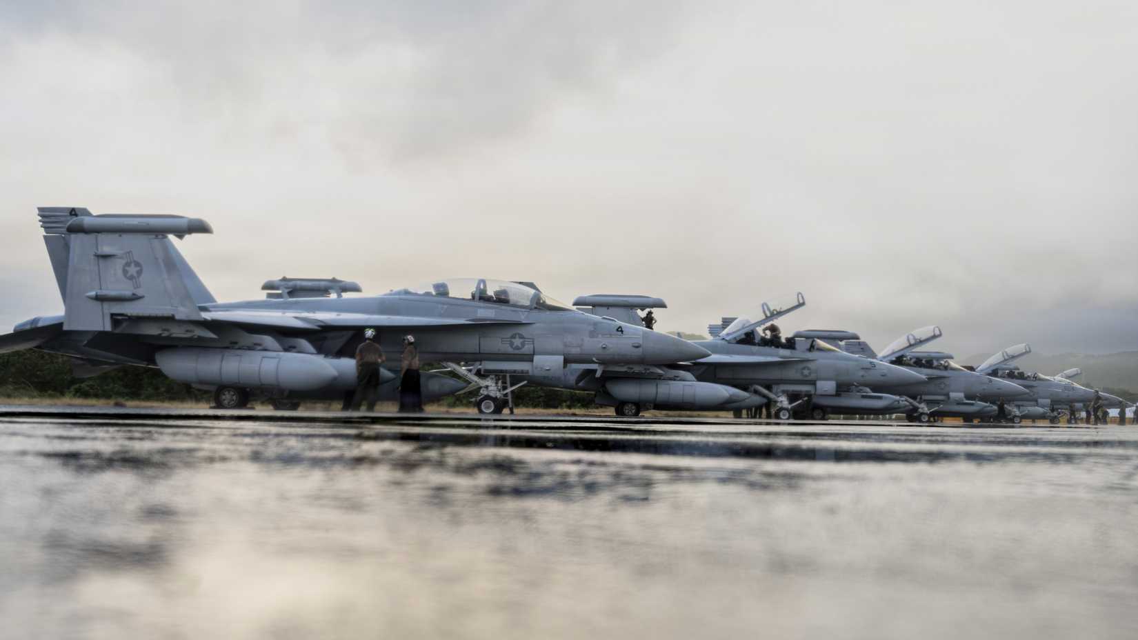 A fleet of U.S. Navy EA-18G Growlers prepare to depart.