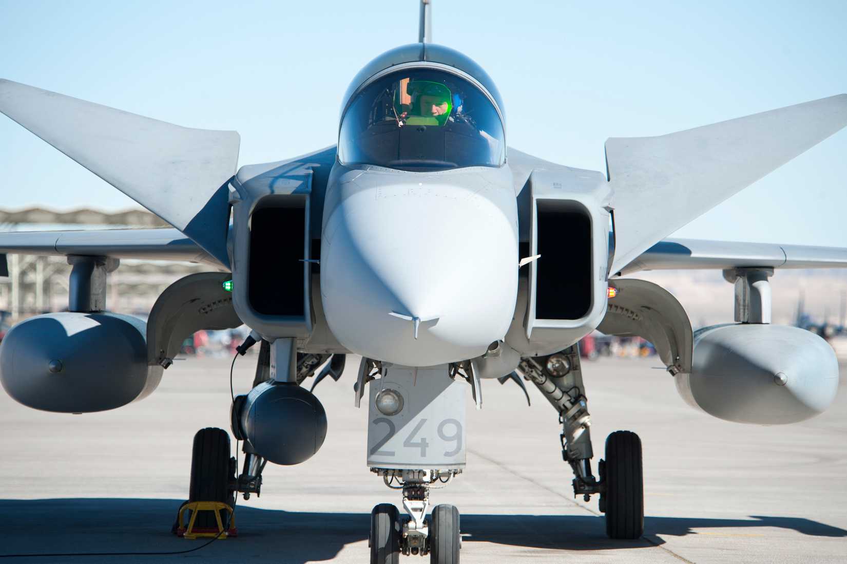 A Swedish Air Force pilot assigned to the 172nd Fighter Squadron, performs a pre-flight inspection on a Saab JAS-39C Gripen