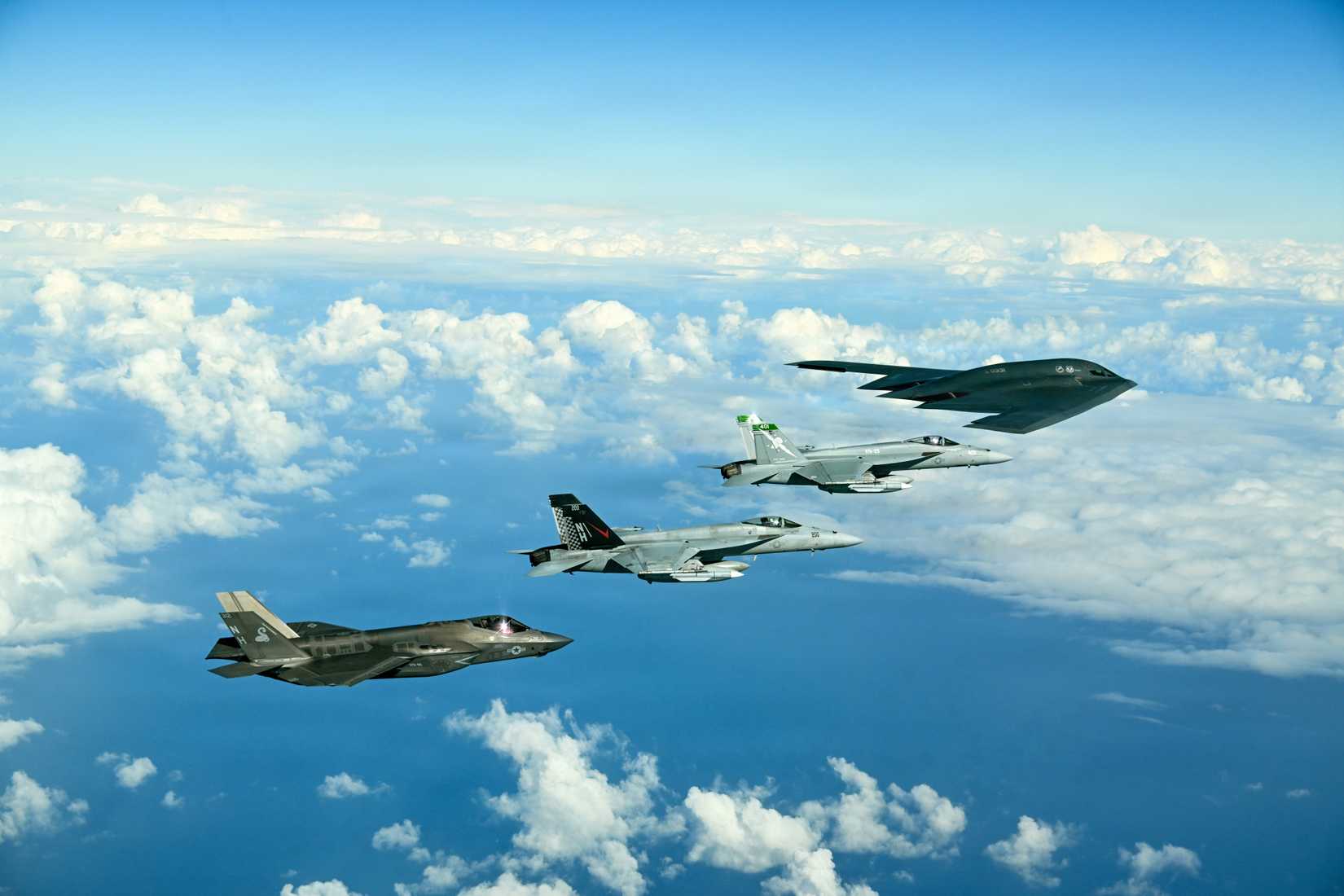 A U.S. Air Force B-2 Spirit conducts an integrated training with Navy F-35C Lightning II and F⁄A-18E Super Hornets from Carrier Air Wing Eleven.jpg