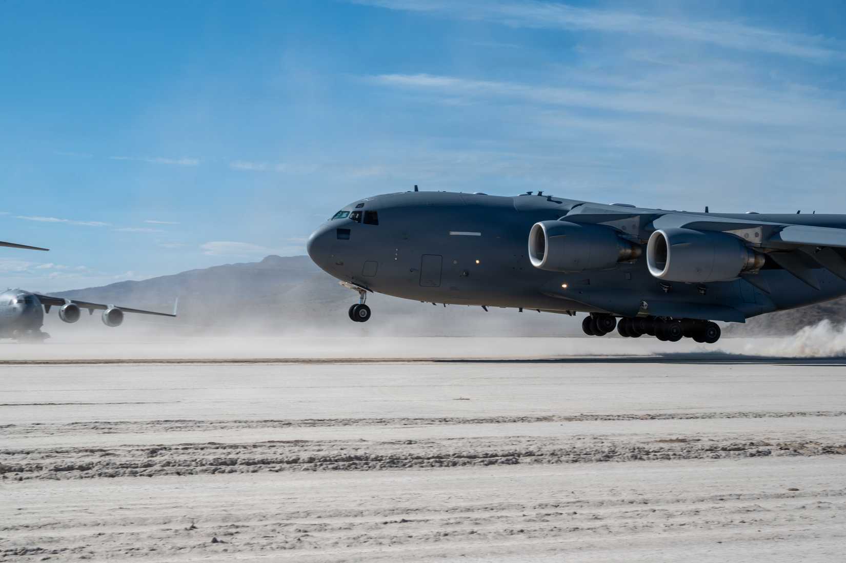 A U.S. Air Force C-17 Globemaster III aircraft, assigned to the 57th Weapons Squadron, takes off from a dirt runway at Delamar Dry Lake near Alamo