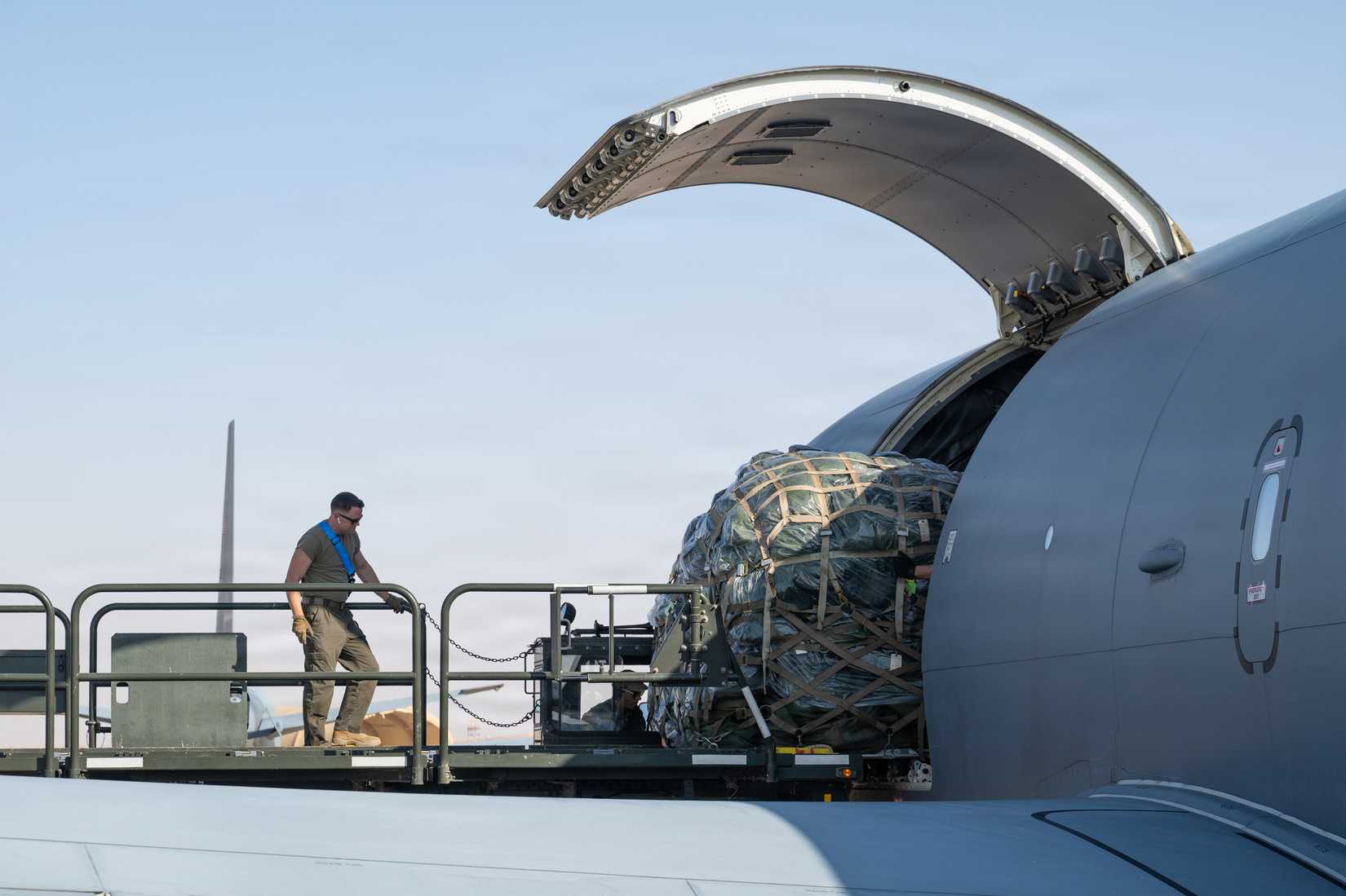 Air Force 378th Expeditionary Logistics Readiness Squadron Airmen unload cargo from a 77th Expeditionary Air Refueling Squadron KC-46A Pegasus