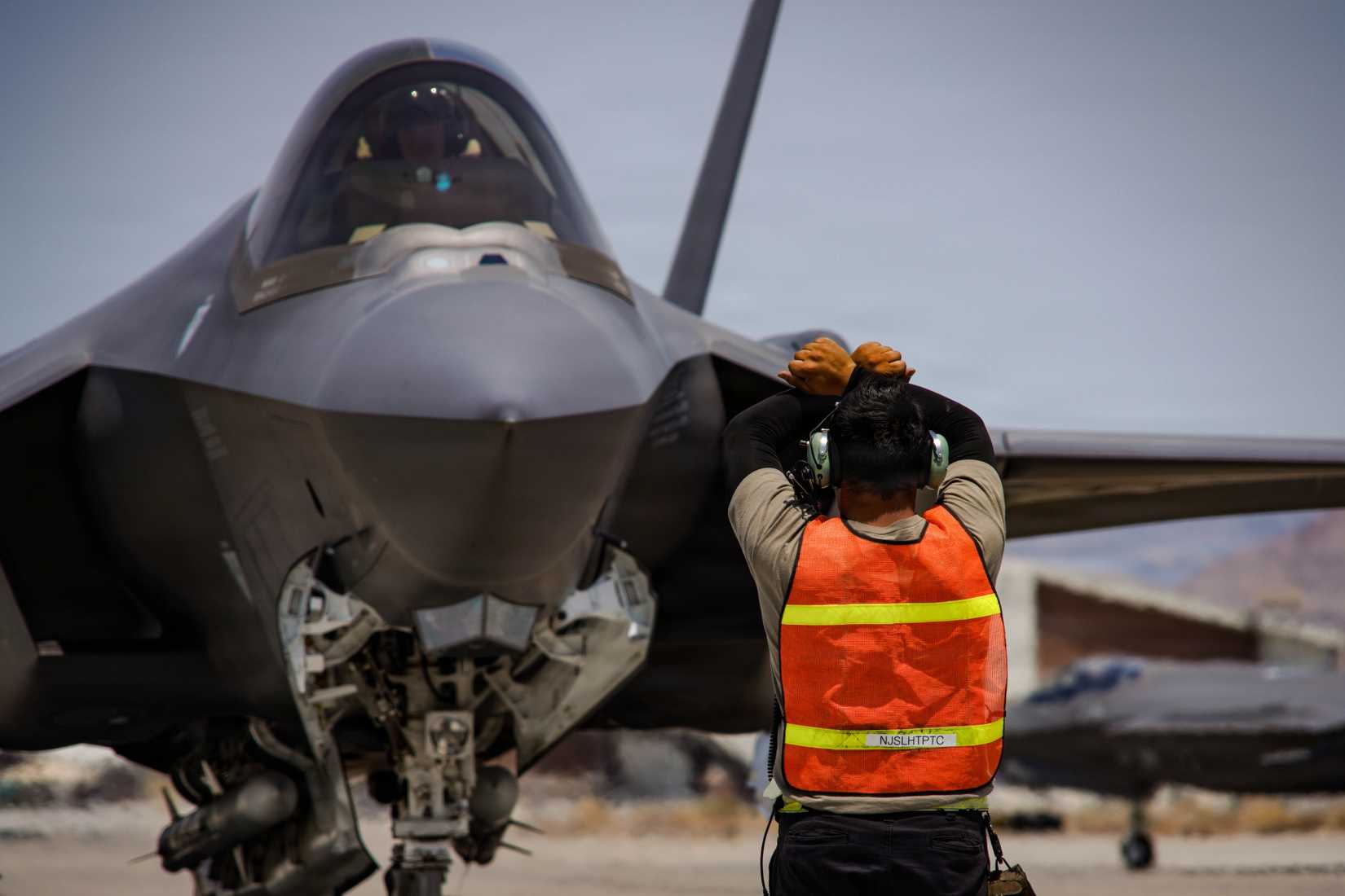 Air Force F-35A Lightning II aircraft assigned to the 65th Aggressor Squadron gets marshalled on the flightline at Creech Air Force Base, Nevada