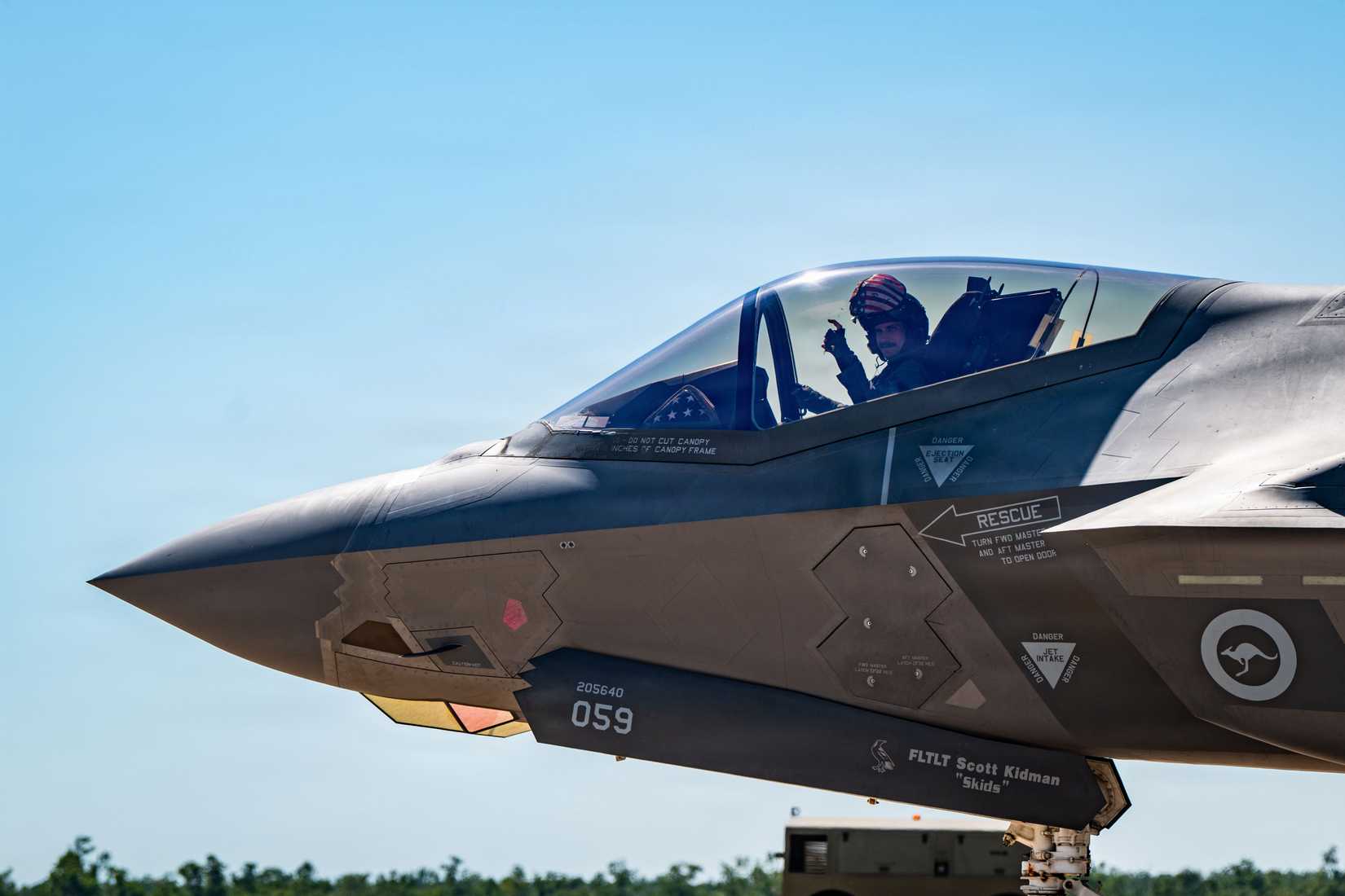 Air Force Lt. Col. Chris Severino, 355 Fighter Squadron director of operations, makes a hand signal while taxiing on the flight line in a Royal Australian Air Force (RAAF) F-35A