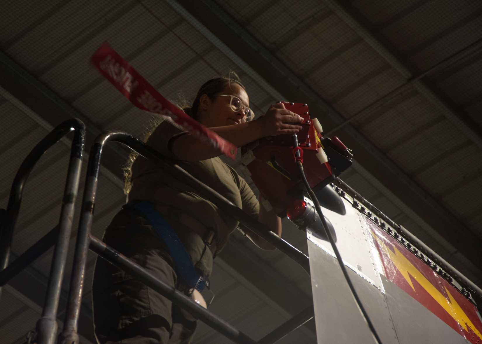 Air Force Senior Airman Vanessa Torres, 87th Electronic Warfare Squadron combat shield technician, installs a Radar Warfare Receiver (RWR) and the USM-642 to an F-15E Strike Eagle.