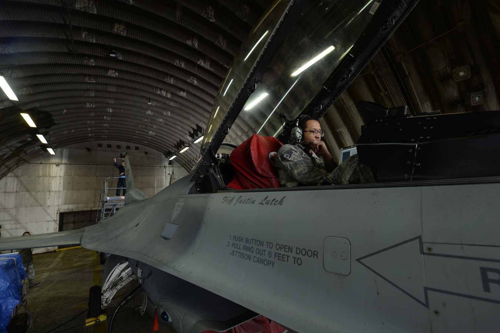 Air Force Staff Sgt. Lamonte McCoy works with Staff Sgt. Gage Trout to certify an F-16 Fighting Falcon radar warning receiver, electronic attack pod and integrated EW system.