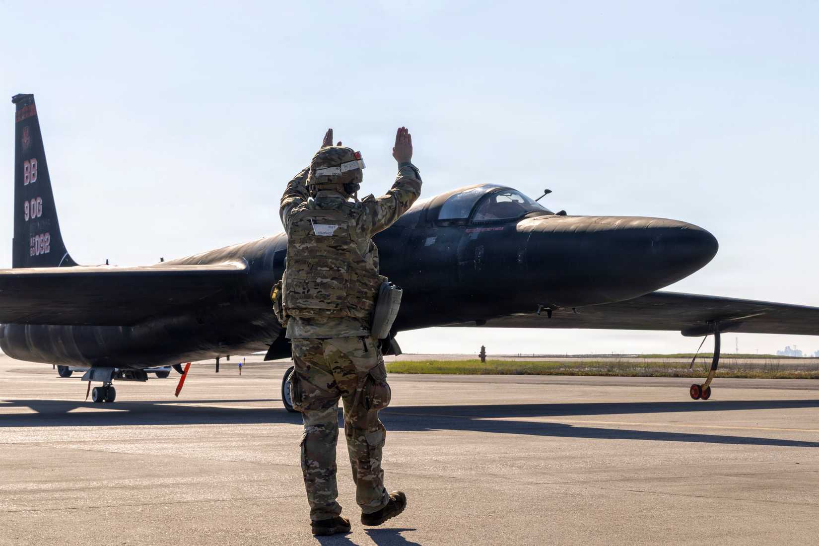 Air Force Staff Sgt. Noah Shumaker, 9th Aircraft Maintenance Squadron U-2 Dragon Lady crew chief, marshals in a U-2 as it returns from flight operations