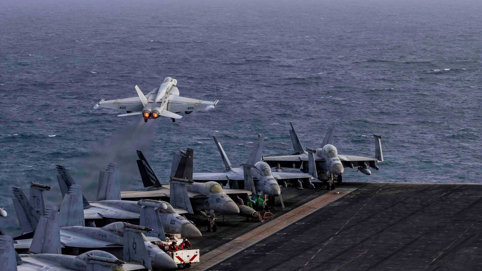 An F⁄A-18E Super Hornet, attached to Strike Fighter Squadron (VFA) 151, launches from the flight deck of Nimitz-class aircraft carrier USS Abraham Lincoln (CVN 72)