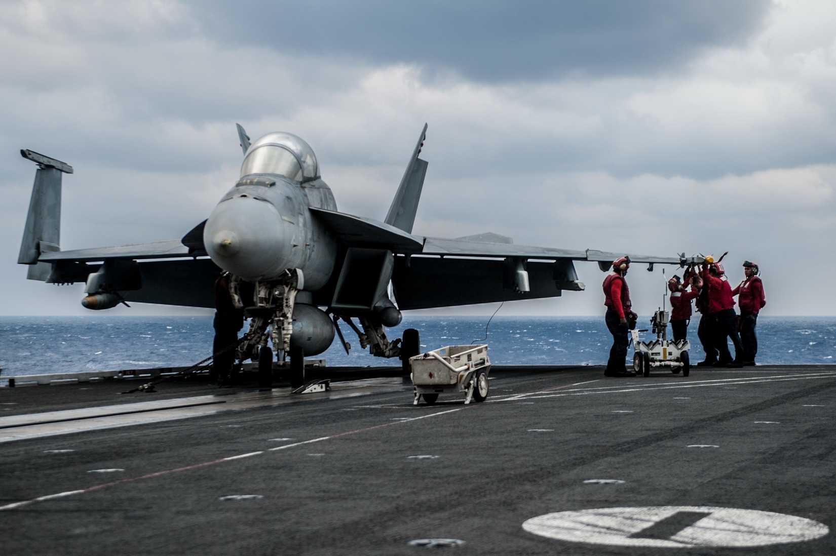 Sailors assigned to the %22Diamondbacks%22 of Strike Fighter Squadron (VFA) 102, load an AIM-9X Sidewinder missile onto an F?A-18F Super Hornet