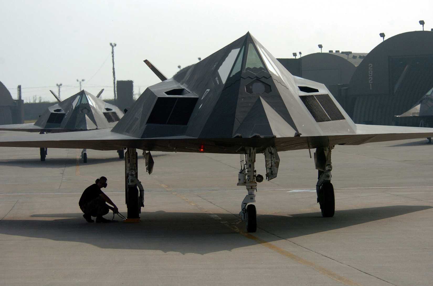 Senior Airman Tony Kepo'o prepares to pull the landing gear wheel chock of an F-117 Nighthawk fighter during an end of runway check at Kunsan Air Base, Korea, on Aug. 15, 2004.
