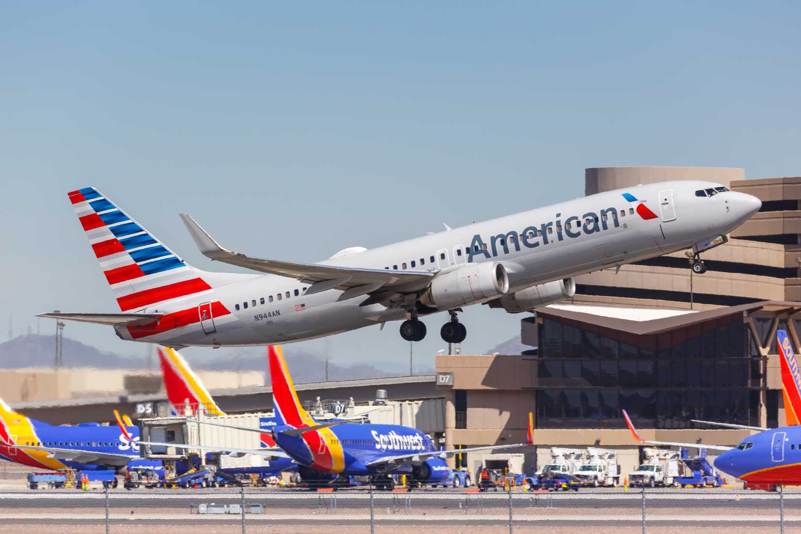 American Airlines Boeing 737-800 aircraft; Southwest Airlines aircraft parked in the background