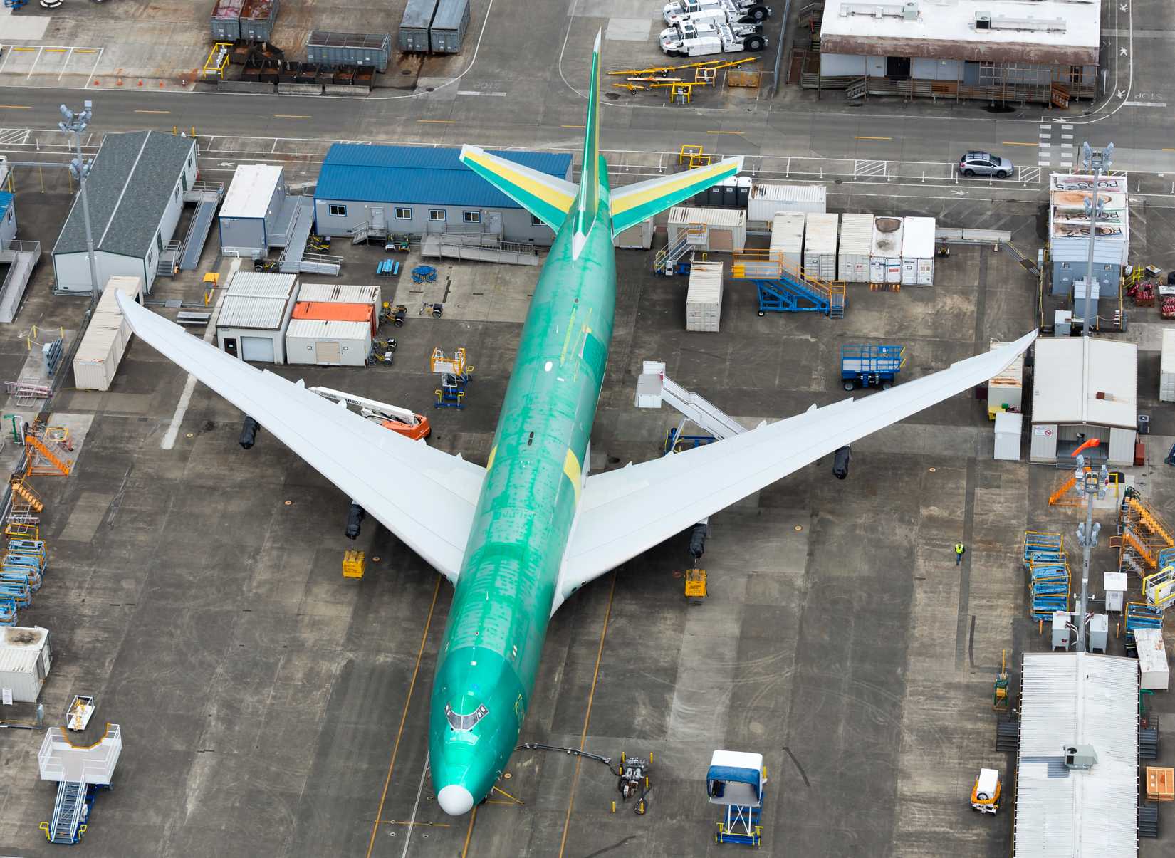 Everett, Washington / USA - May 22 2016: Boeing 747 Freighter version wearing the green anti corrosion coat at Paine Field. Stairs and ground equipment visible around. Also referred as B747 or 747-8F.