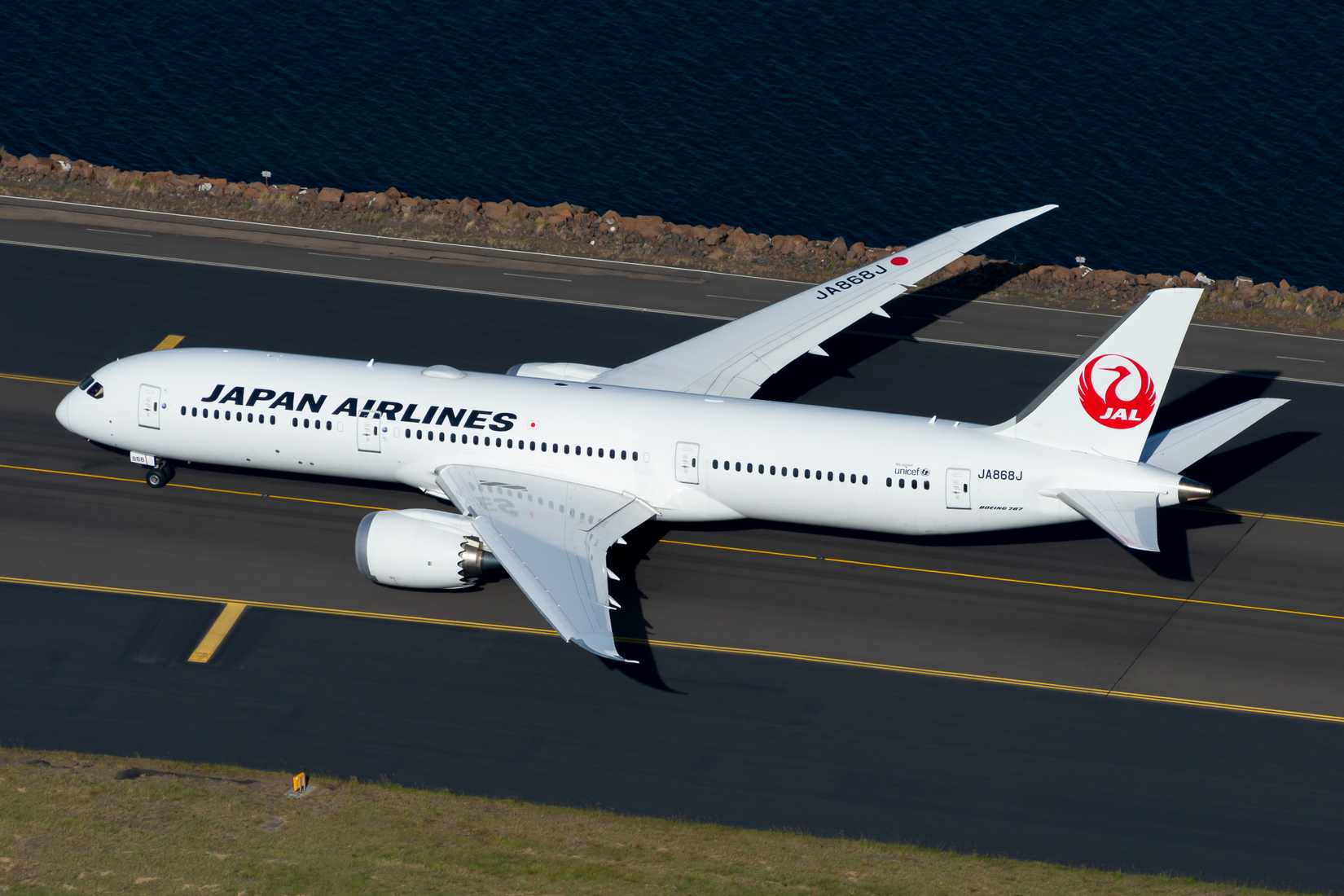 Japan Airlines Boeing 787-9 Dreamliner taxiing in airport seen from above