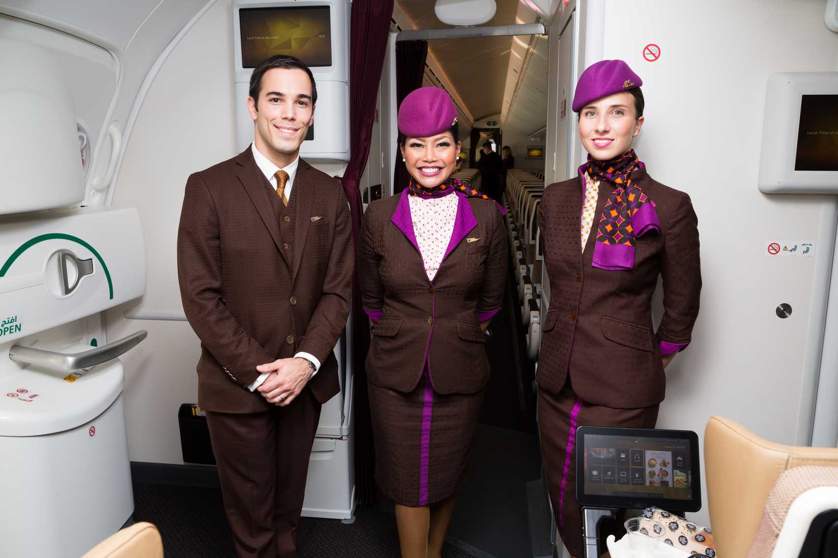 Etihad cabin crew standing by cabin door