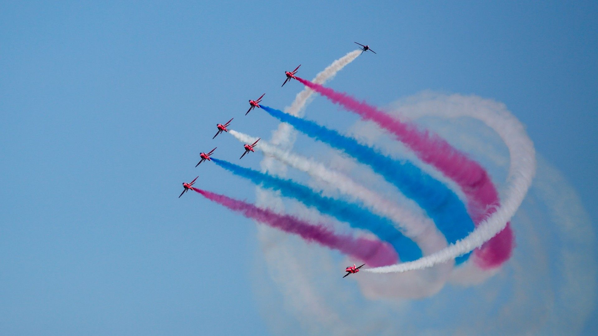 The Red Arrows Showcasing A Spiral Smoke Maneuver