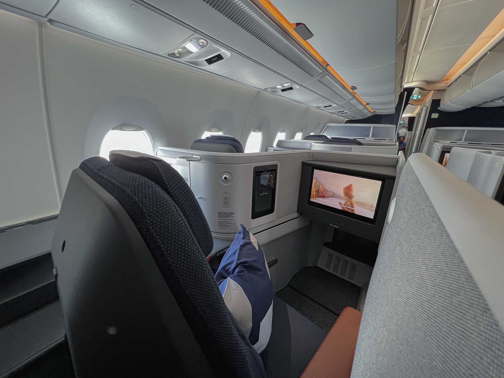 New Lufthansa Allegris long-haul Business Class cabin with fully enclosed suites with doors, staggered lie-flat seating layout onboard Airbus A350 taken at Munich Airport on 24 August 2024