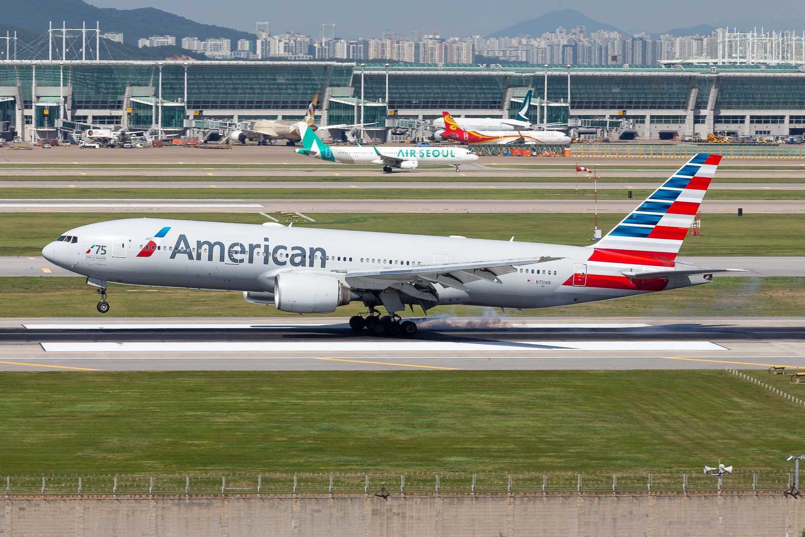 Incheon, South Korea - Jul 27 2025: A Boeing 777-200ER of American Airlines touches down at Incheon International Airport in South Korea.