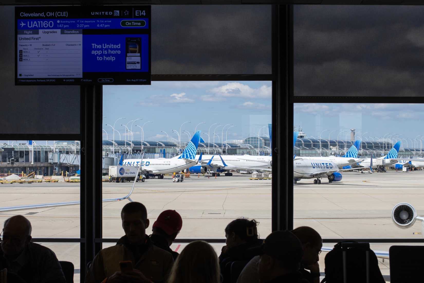 Passengers waiting in the boarding area for a United Airlines flight