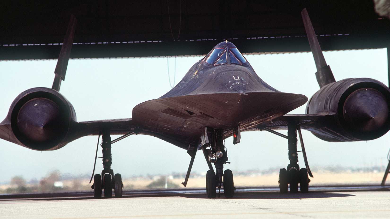 SR-71 Blackbird aircraft, from the 9th Strategic Reconnaissance Wing, taxiing out of a hangar