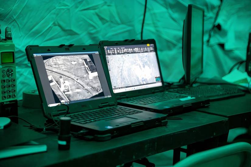 A photo of military laptops with targeting information on the screens.
