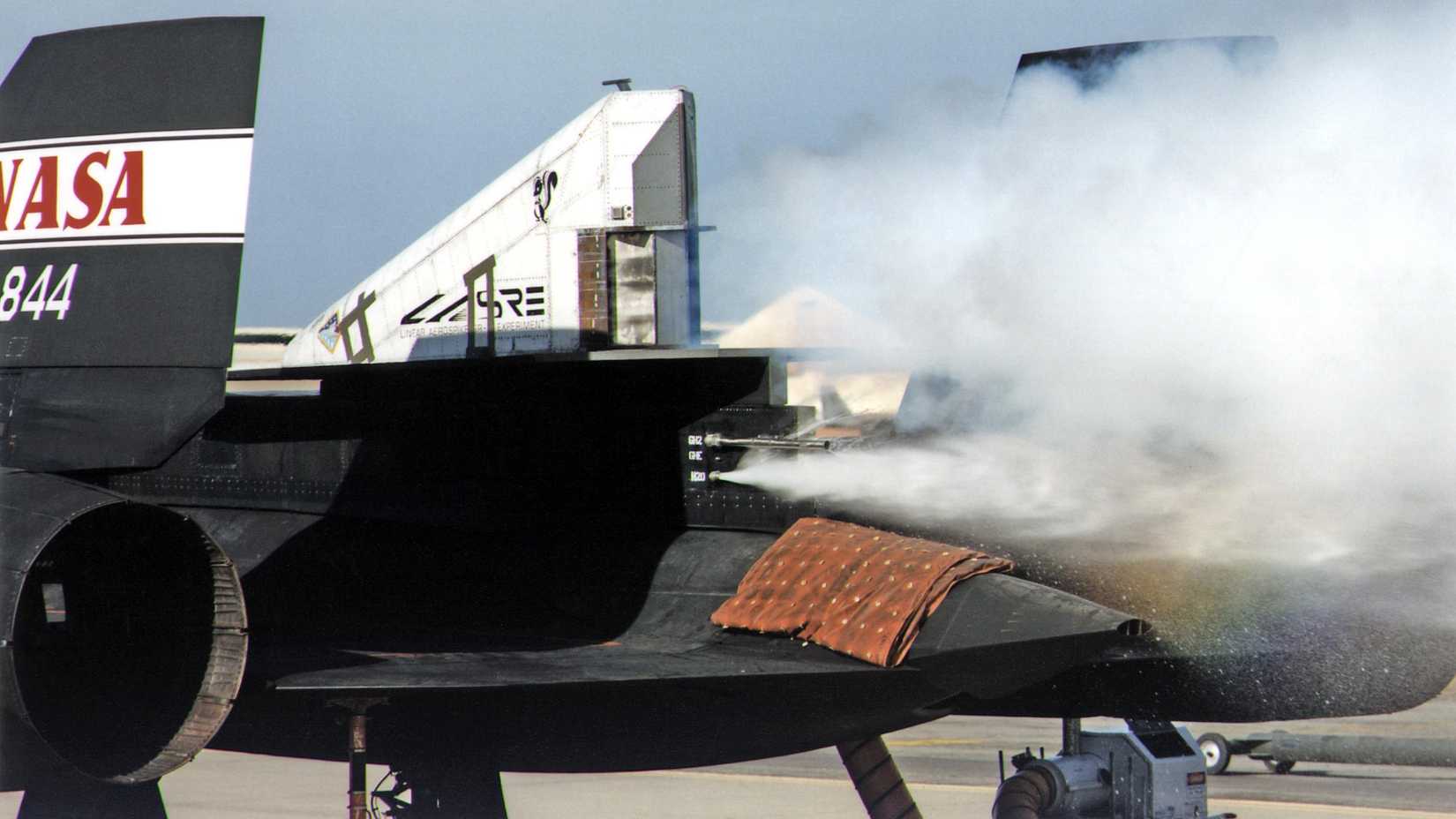 This photograph shows a ground cold flow test of the linear aerospike rocket engine mounted on the rear fuselage of an SR-71