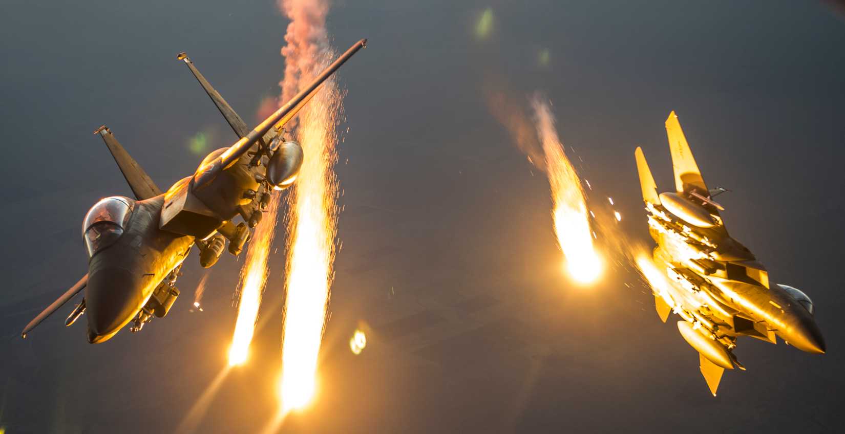 Two F-15 Eagles drop flares after receiving fuel from a KC-135 Stratotanker over Iraq in support of Operation Inherent Resolve July 8, 2016.