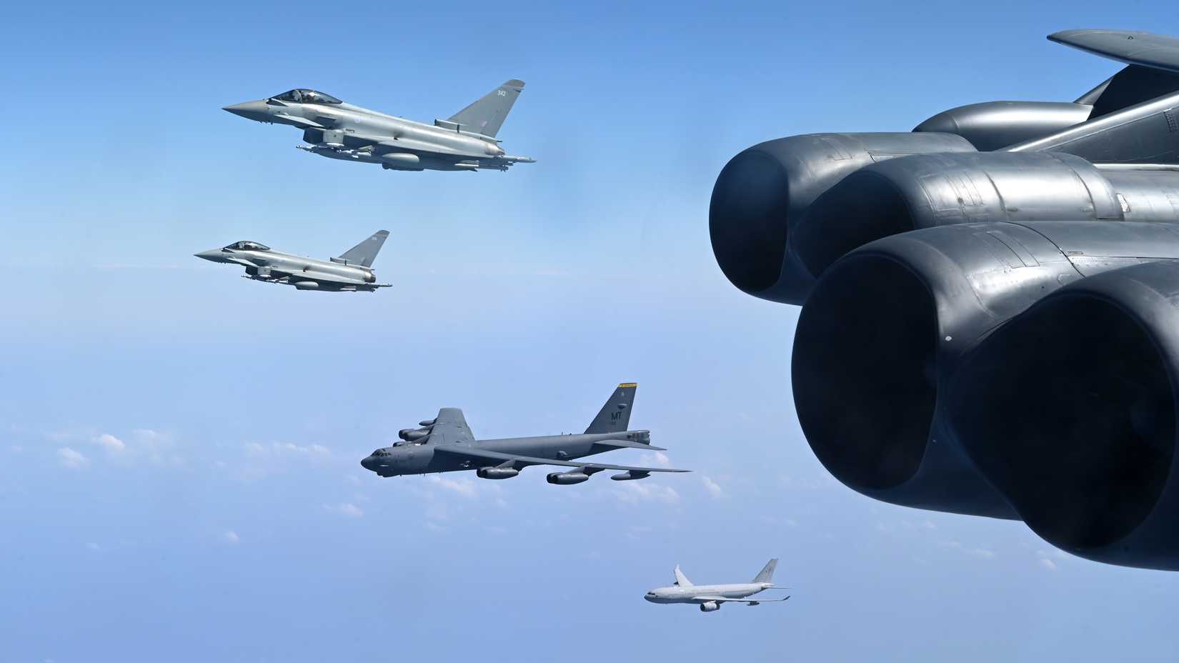Two Royal Air Force Eurofighter Typhoons and a RAF Voyager aerial refueler fly in formation with two U.S. Air Force B-52H Stratofortress strategic bombers 